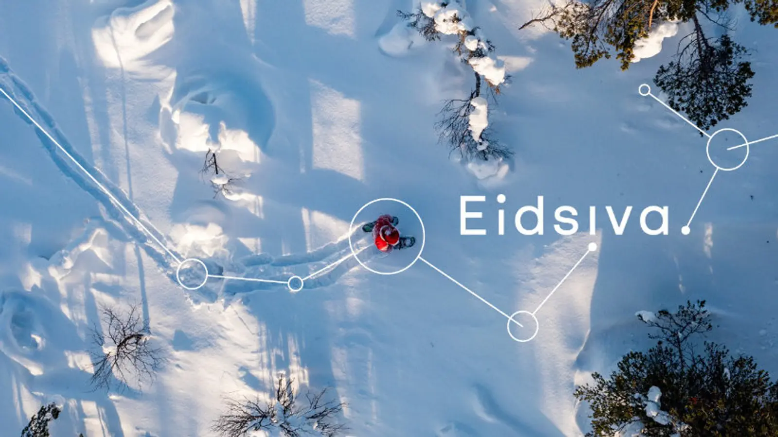Bilde av en person som går i snøen med Eidsiva skrevet over