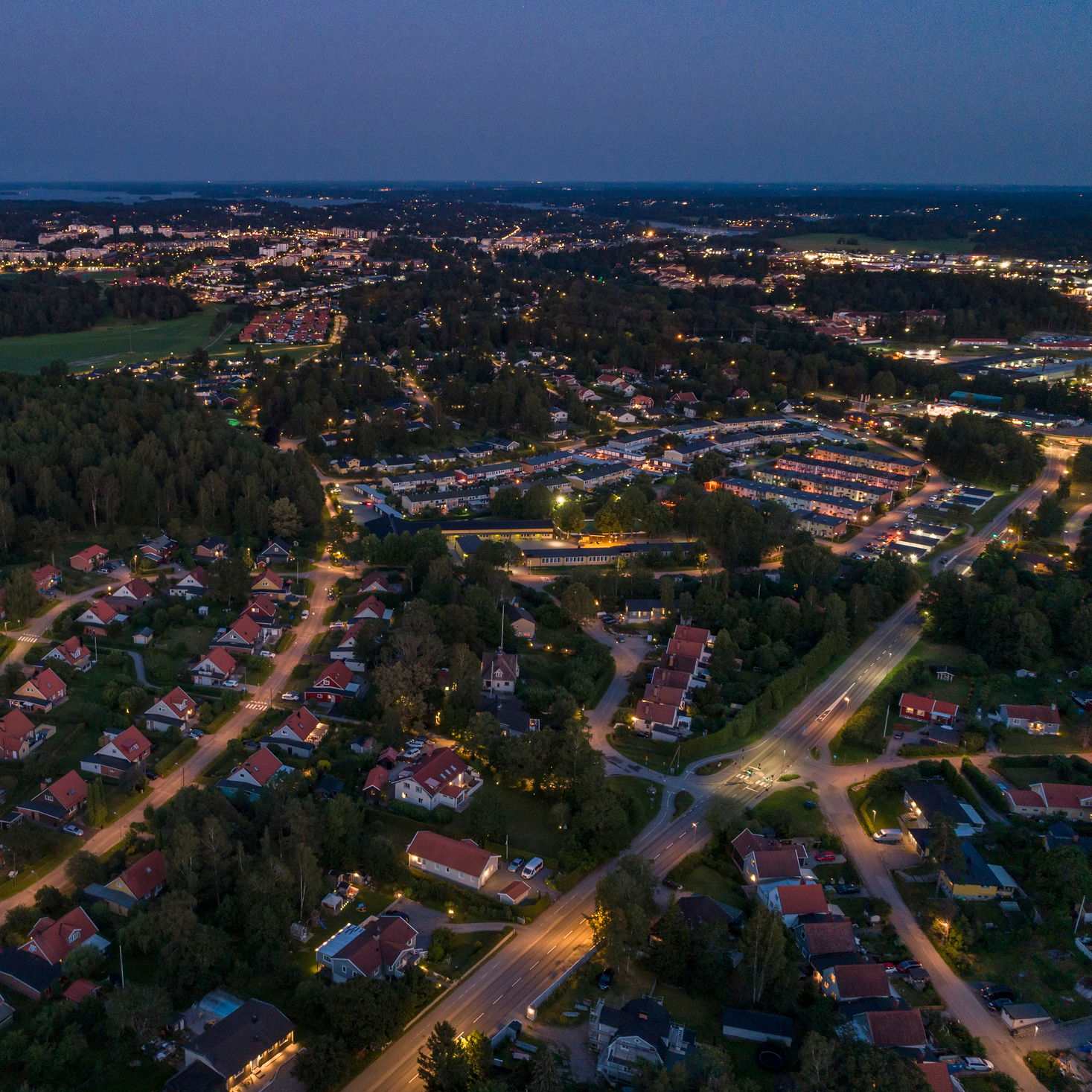Ett upplyst bostadsområde på kvällen.